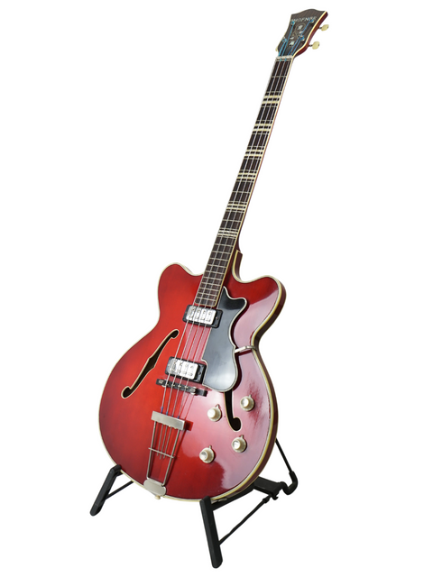 A classic red Hofner Verithin Bass guitar from 1961, Germany, prominently positioned on a stand.