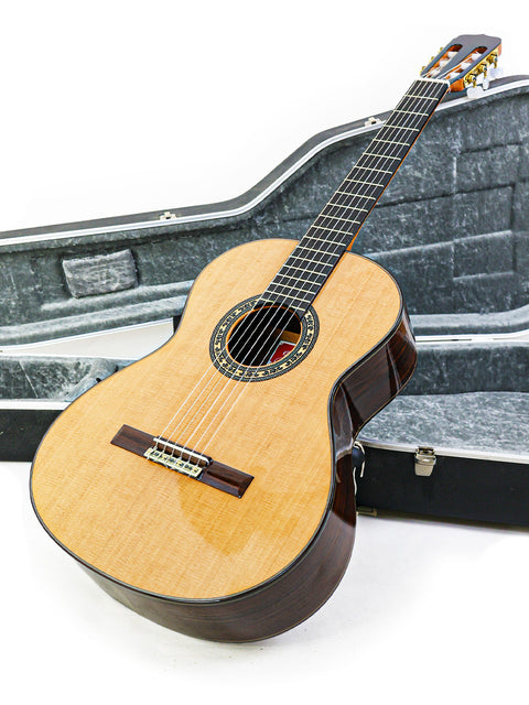 A classical guitar, José Ramírez Estudio 3 from Spain (2019), nestled in its case on a pristine white background.