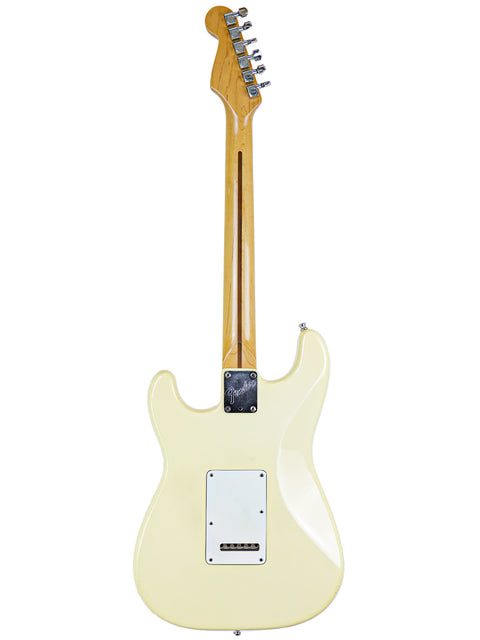 A cream-colored electric guitar viewed from the back with a visible neck and tuners.