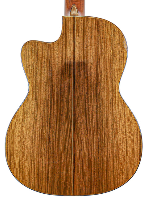 A detailed look at the back of a Robin Moyes Custom acoustic guitar, featuring a rich wooden finish, made in Australia, 2002.
