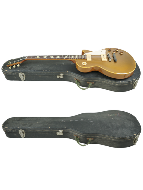 A gold-finished case holds two guitars, including a Gibson Custom Shop Les Paul 1956 Reissue LPR-6 Grubisa Relic.