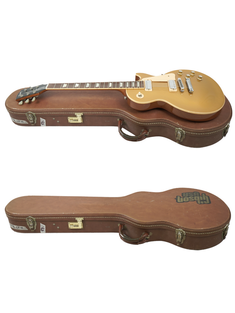  A gold-finished case holds two guitars, including the Gibson Les Paul Deluxe Limited Edition 30th Anniversary, USA 2000.
