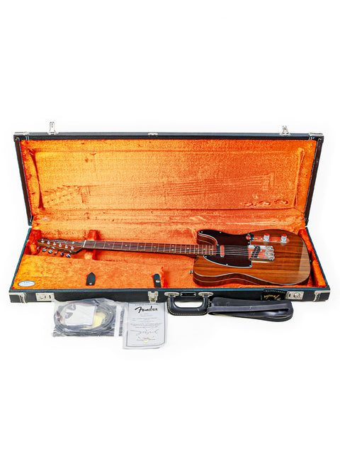 A limited edition Fender Telecaster guitar rests in its case, featuring a guitar strap, highlighting its craftsmanship and elegance.

