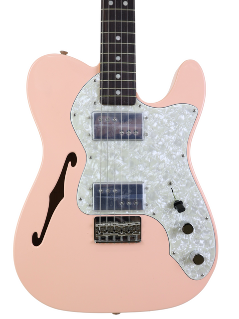 A pink electric guitar with a white pickguard and dark fretboard.