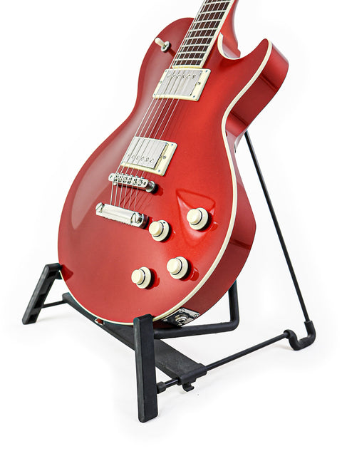  A red Collings CL Deluxe guitar on a stand, featuring a minimalist white background that emphasizes its stunning craftsmanship.