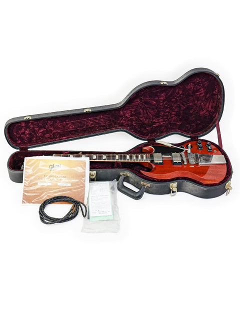 A red Gibson Custom Les Paul SG Standard guitar is securely placed in a black case, reflecting its premium quality and design.