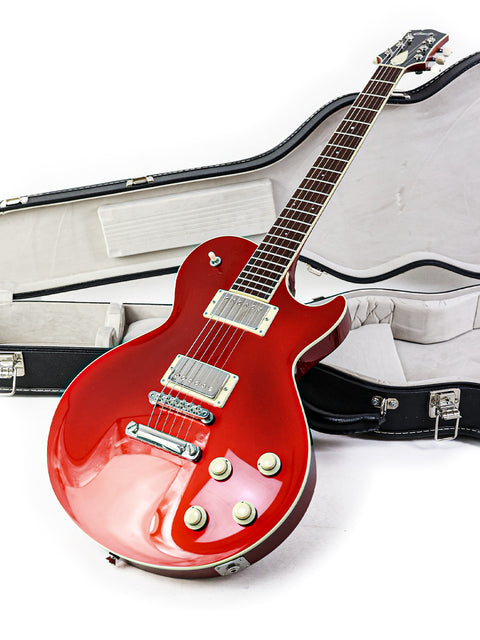 A red electric guitar in a case, showcasing the Collings CL Deluxe model from the USA, crafted in 2019.