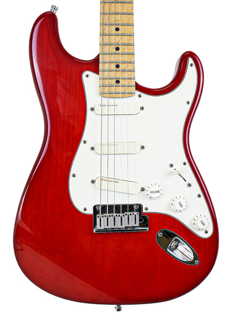 A red electric guitar with a white body, featuring the Fender Strat Plus Deluxe model from the USA, 1993.
