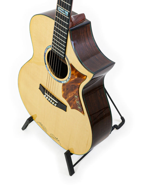 A sleek James Cargill Custom guitar from Australia, resting on a stand with a bright white background highlighting its features.