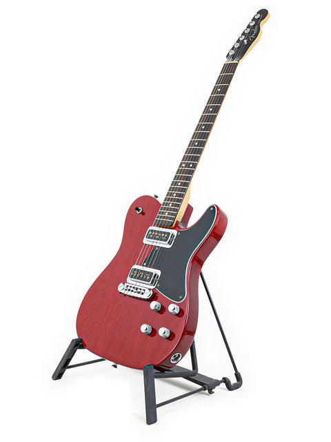 A striking red Fender Tele-Sonic electric guitar from 2001 resting on a stand, emphasizing its bold color and craftsmanship.