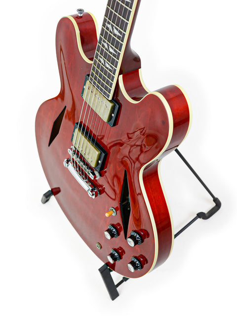 A striking red guitar featuring a black body and white headstock, the Gibson Custom Shop Trini Lopez, USA 2009 model.