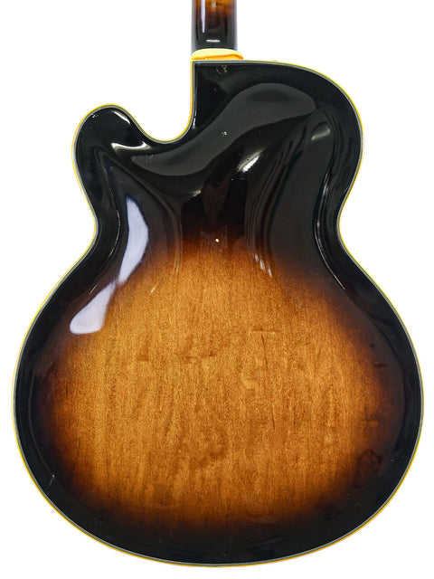 A striking sunburst Gibson guitar displayed with an Ibanez JP20 Joe Pass Signature model, crafted in Japan in 1982.
