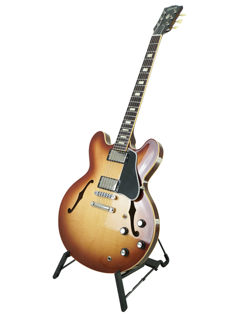 A stunning Gibson Custom ES-335 Iced Tea guitar resting on a stand, highlighting its rich color and iconic shape.