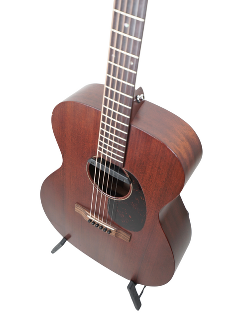 A stunning Martin 000-15M guitar displayed on a stand, set against a bright white backdrop.