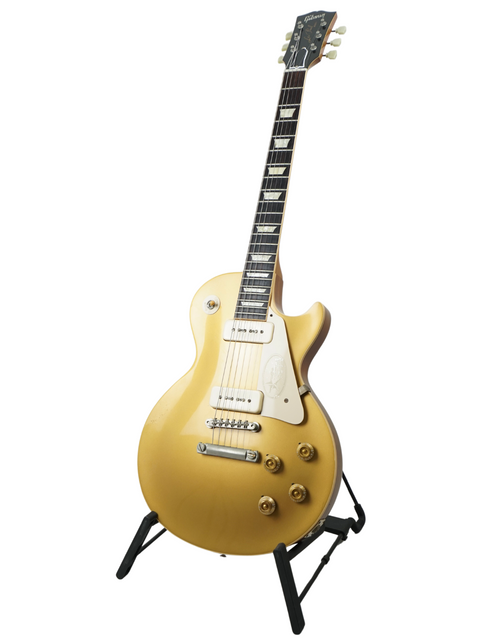 A stunning gold electric guitar on a stand, the Gibson Custom Historic VOS LPR-6 1956 Reissue Gold Top, made in 2011.