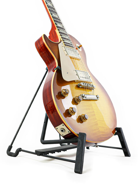 A stunning left-handed Gibson Custom Shop LPR-8 guitar displayed on a stand, set against a bright white backdrop.
