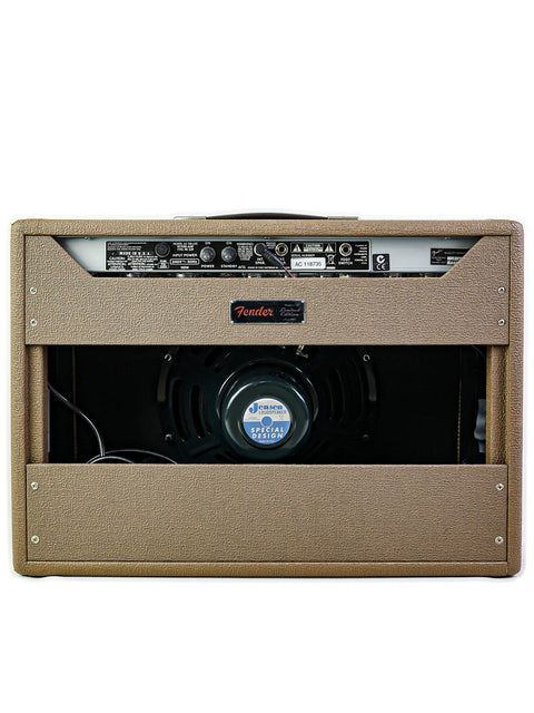 A tan guitar amplifier, the Fender '65 Deluxe Reverb Limited Edition, featuring a prominent front speaker.