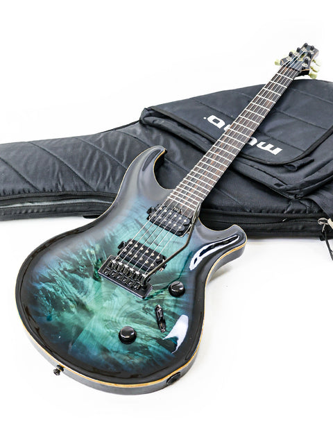 A vibrant green guitar is displayed next to a sleek black case, marked 'Orthius Deluxe DC - Australia 2018'.