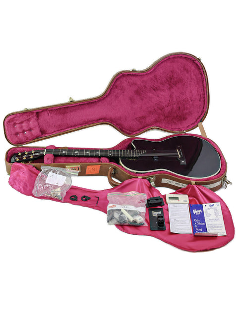 A vibrant pink guitar case featuring a Gibson Chet Atkins SST guitar from 2001, highlighting its unique style and quality.