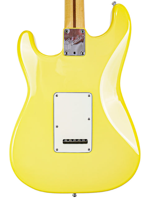 A vibrant yellow Fender electric guitar body with a white backplate and neck attachment.