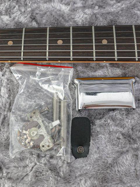 A vintage 1963 Fender L-Series Stratocaster guitar in a plastic case, featuring a key for locking it up.