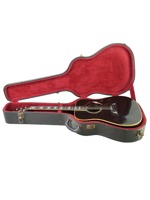 A vintage 1977 Gibson Dove Custom guitar, black and sleek, showcased in a red case on a white surface.