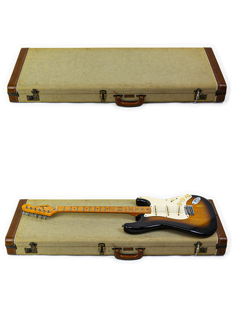  A vintage Fender AVRI ‘57 Stratocaster in its case, alongside another case displaying a guitar outside.
