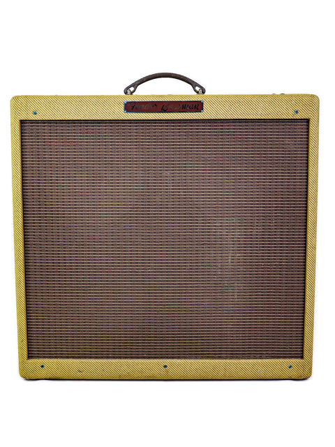 A vintage Fender Bassman guitar amplifier with a yellow tweed cover.