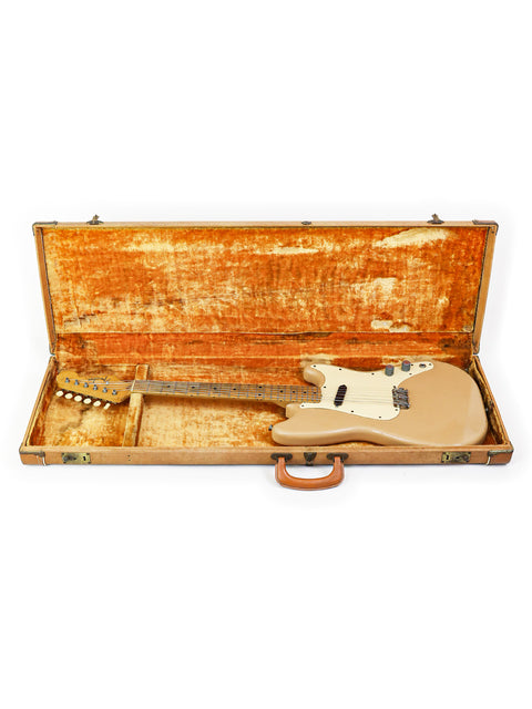 A vintage Fender Musicmaster Telecaster from 1957, securely placed in a wooden case, ready for its next performance.