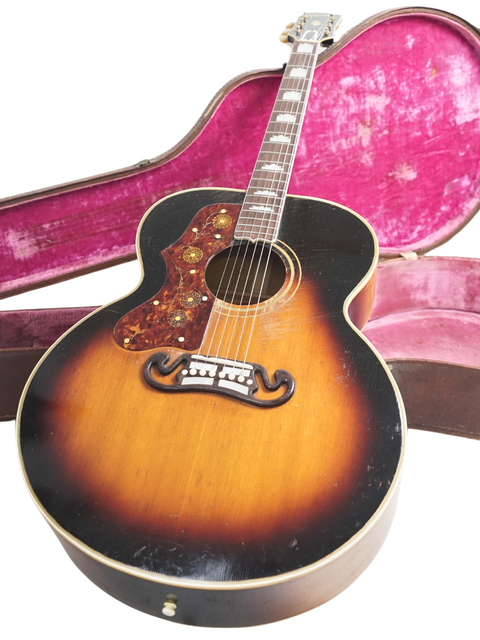 A vintage Gibson J-200 left-handed guitar from 1955, securely placed inside its case, ready for music lovers.