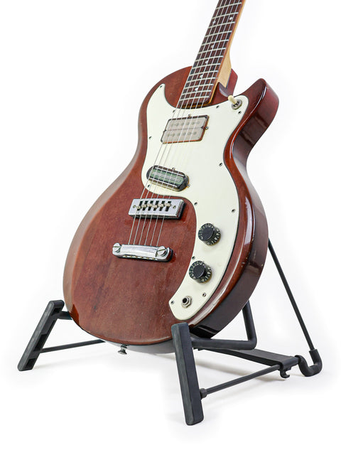 A vintage Gibson Marauder guitar from 1975 showcased on a stand with a simple white background.