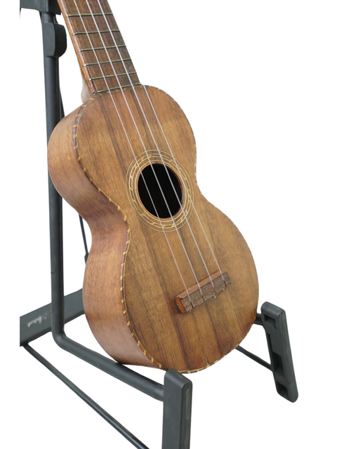 A vintage Kumalae Model D ukulele, circa 1920, showcased on a stand, highlighting its Hawaiian craftsmanship.