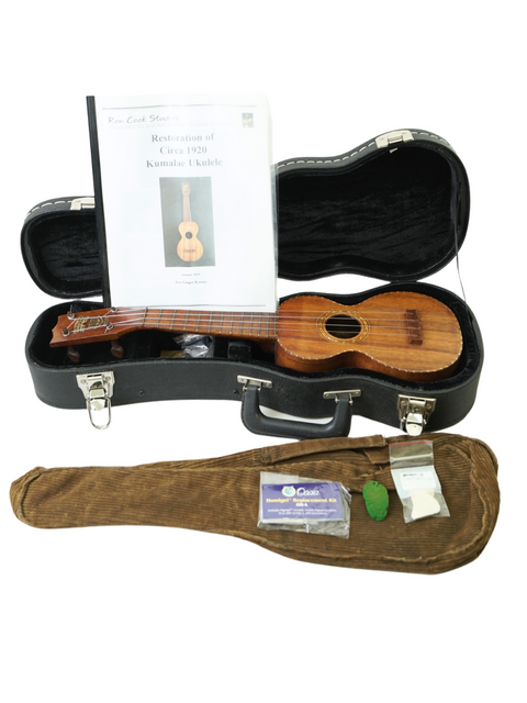 A vintage Kumalae Model D ukulele in a case with a guitar and its case, reflecting the musical culture of Hawaii circa 1920.