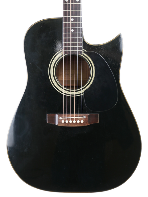 A vintage Maton Tommy Emmanuel 'Ebony' acoustic guitar from 1989, resting on a clean white background.