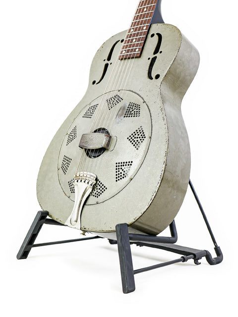 A vintage National Duolian Resonator guitar from 1936 on a stand, showcased with a white background.