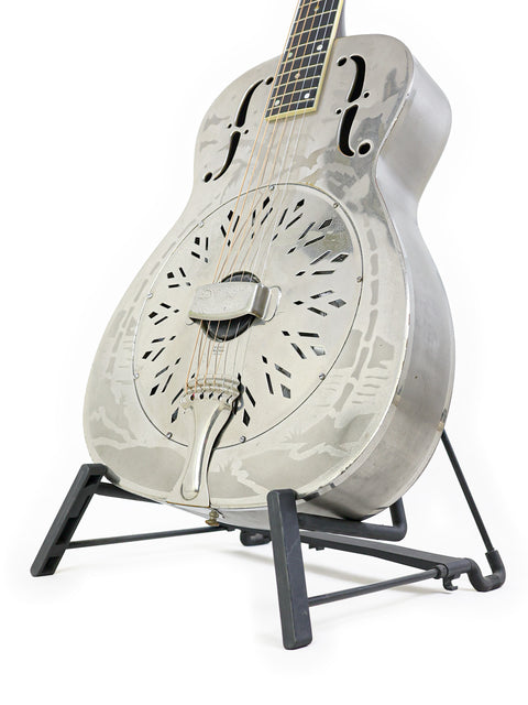 A vintage National Style 'O' guitar from 1934 on a stand, showcased with a plain white background.