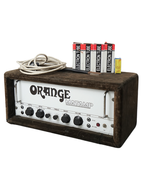 A vintage Orange Matamp 100W head, complete with batteries and charger, reflecting 1970s UK music gear style.
