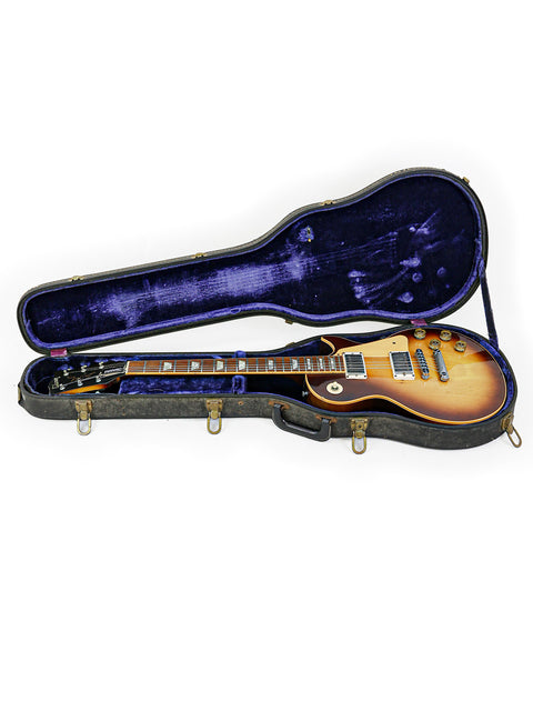 A vintage guitar case containing a 1979 Gibson Les Paul Standard, showcasing its classic design.