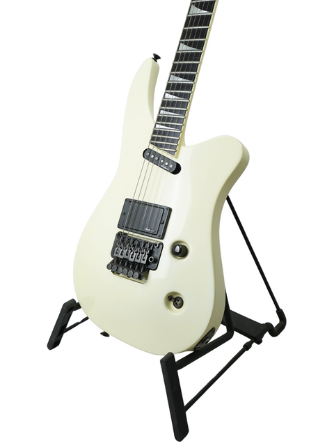 A white electric guitar on a stand, highlighting the Jackson Phil Collen Signature PC1 Archtop, made in the USA in 1989.