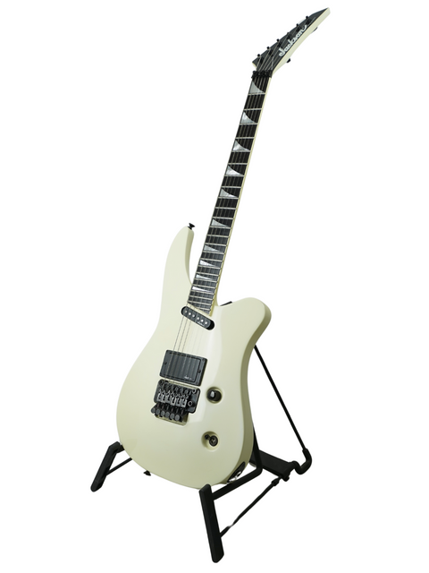 A white electric guitar resting on a stand, representing the Jackson Phil Collen Signature PC1 Archtop, crafted in the USA, 1989.