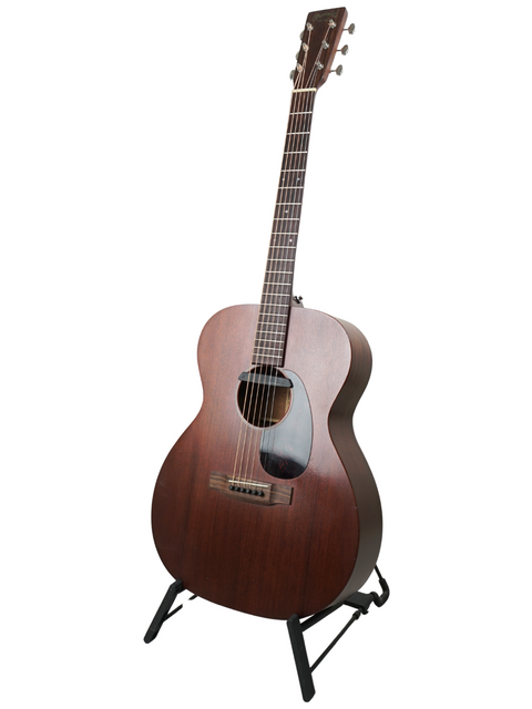A wooden Martin 000-15M acoustic guitar from 2016, proudly positioned on a stand, ready for a jam session.
