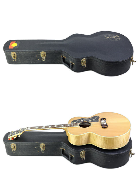 A wooden case holds two guitars, including a 1999 Gibson SJ-200, highlighting their beauty and musical heritage.