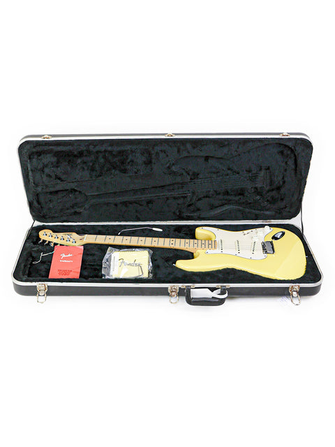A yellow electric guitar with a maple neck in a black case.