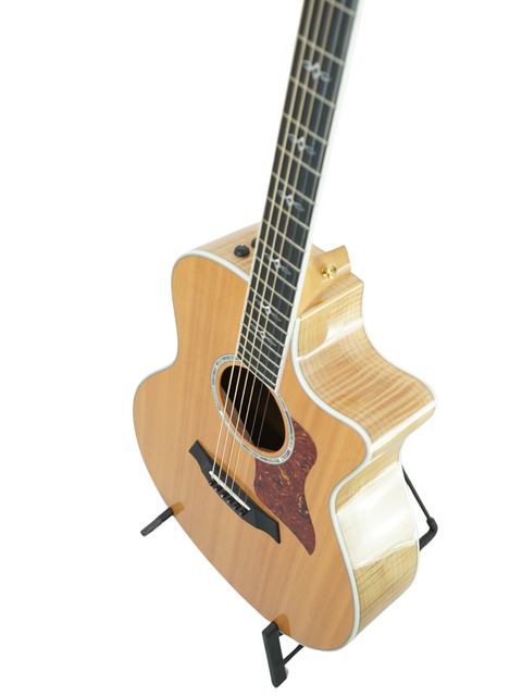 Acoustic guitar on a stand, featuring the Taylor 616ce model from 2011, with a simple white background.