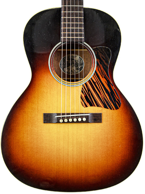 Acoustic guitar with sunburst finish, isolated on a white background.