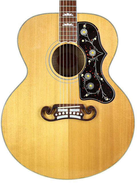 An acoustic guitar featuring a floral design on the back, model Gibson SJ-200, made in the USA in 1999.