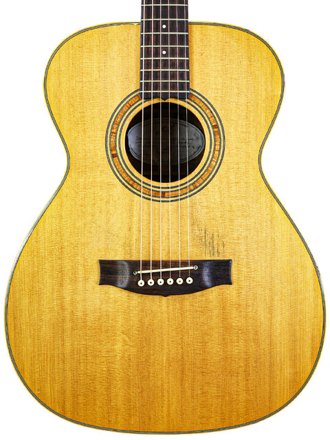 An acoustic guitar rests against a white background, showcasing its elegant design and craftsmanship, labeled Matchless Lightning 15 Combo.