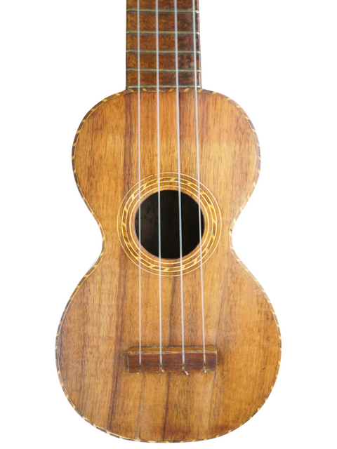 An antique Kumalae Model D ukulele, crafted in Hawaii circa 1920, with a beautifully aged wooden body and neck.