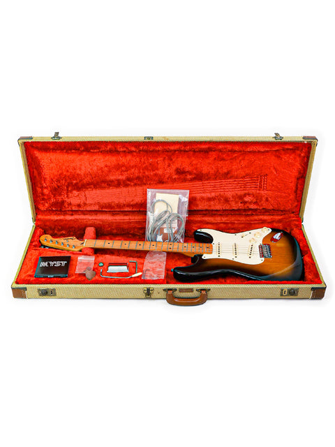 An electric guitar, a 1982 Fender AVRI '57 Stratocaster, is safely stored in its guitar case.