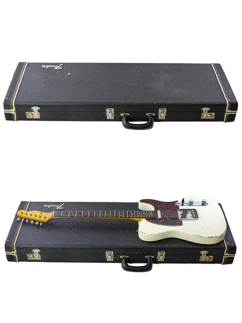  An open case reveals two guitars, featuring a vintage 1963 Fender Telecaster, highlighting their exquisite craftsmanship.